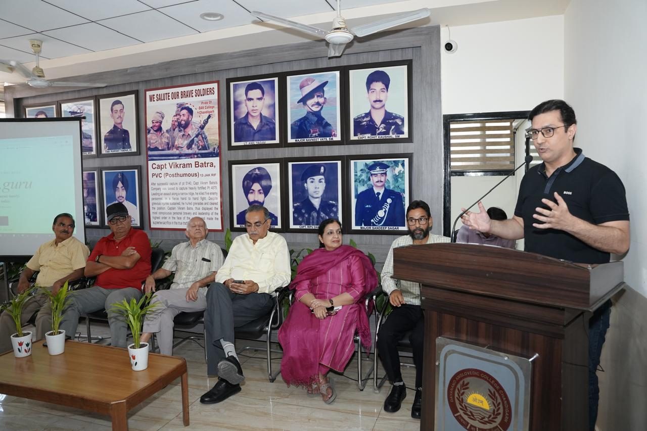 A speaker addresses the gathering, with the dais seated alongside.